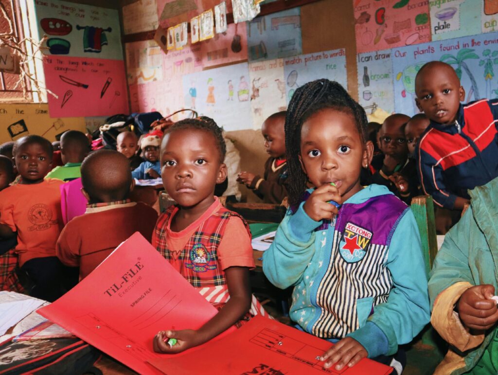 A group of young children engaged in an educational activity in a colorful classroom.